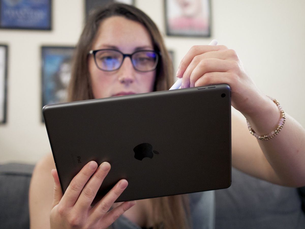 Woman drawing on iPad (2021) in Space Gray