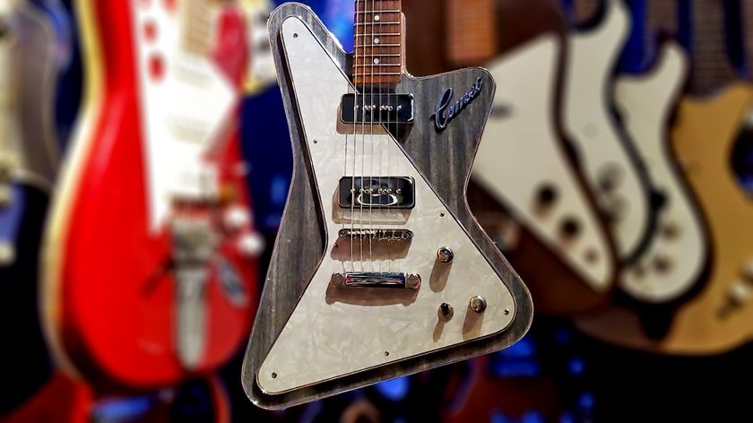 A photo showing the body of a custom Jon Trickey Comet six-string electric guitar hanging among other unusually shaped guitars in the collection of author Terry Carleton.