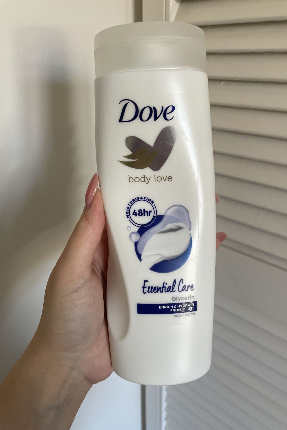 valeza holding the Dove Essential Care body lotion
