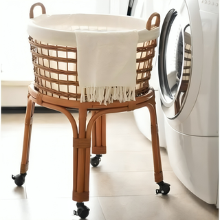 A woven rattan laundry basket on a wheeled base