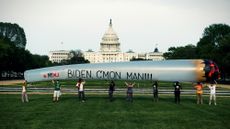 Pro-marijuana protesters hold a giant inflatable joint in front of Congress