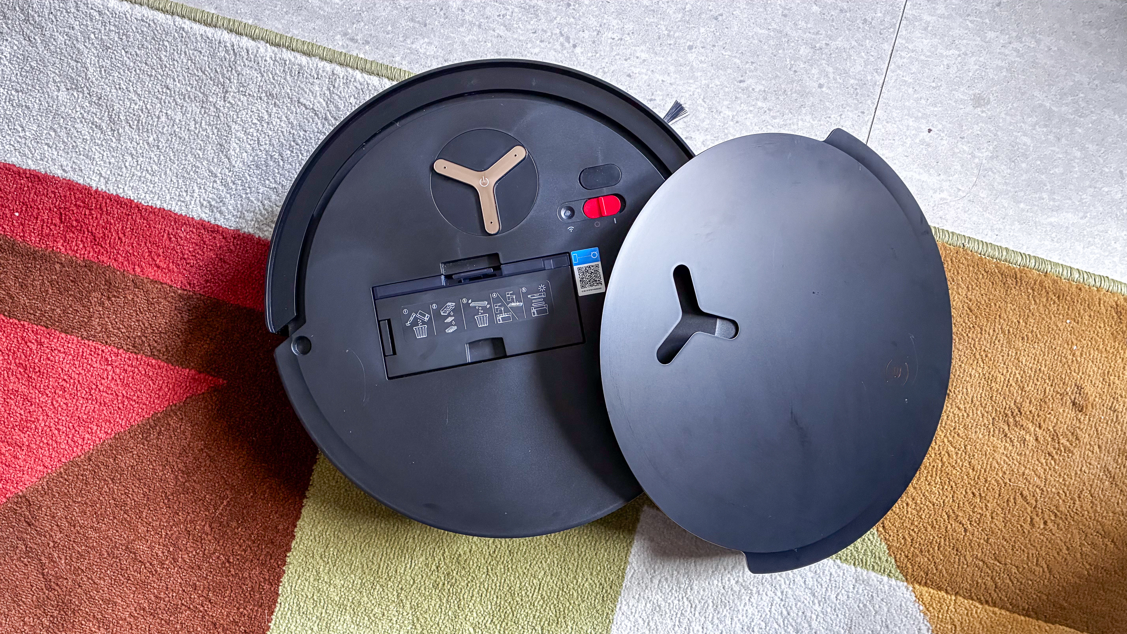 The buttons and bin under the cover of the Ecovacs Deebot X8 Pro Omni robot vacuum