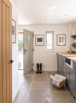 utility room with belfast sink and stone floor
