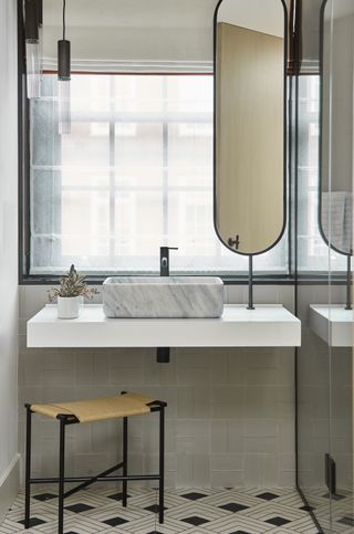a bathroom basin in front of a window