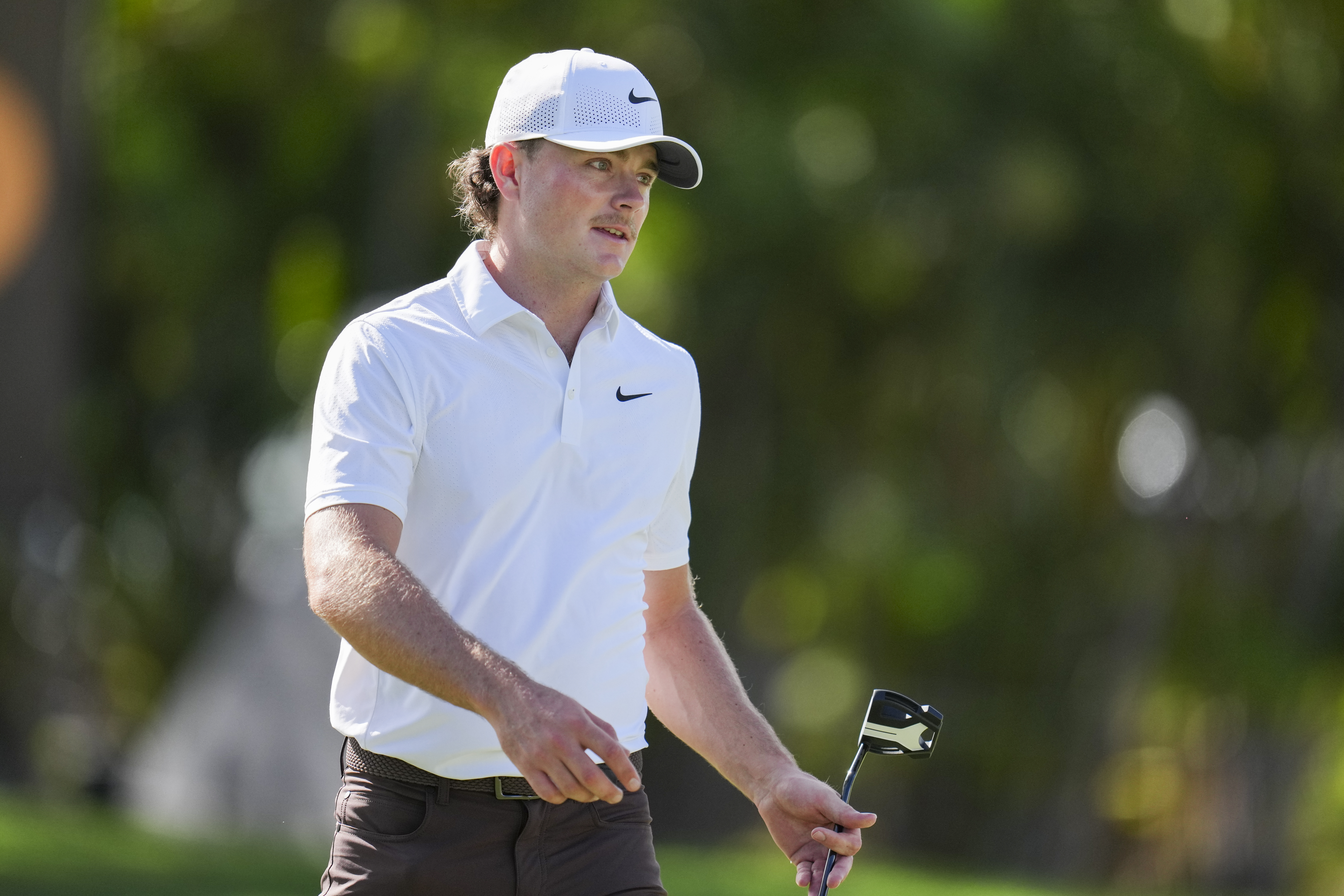 Luke Clanton walks on the green with his putter
