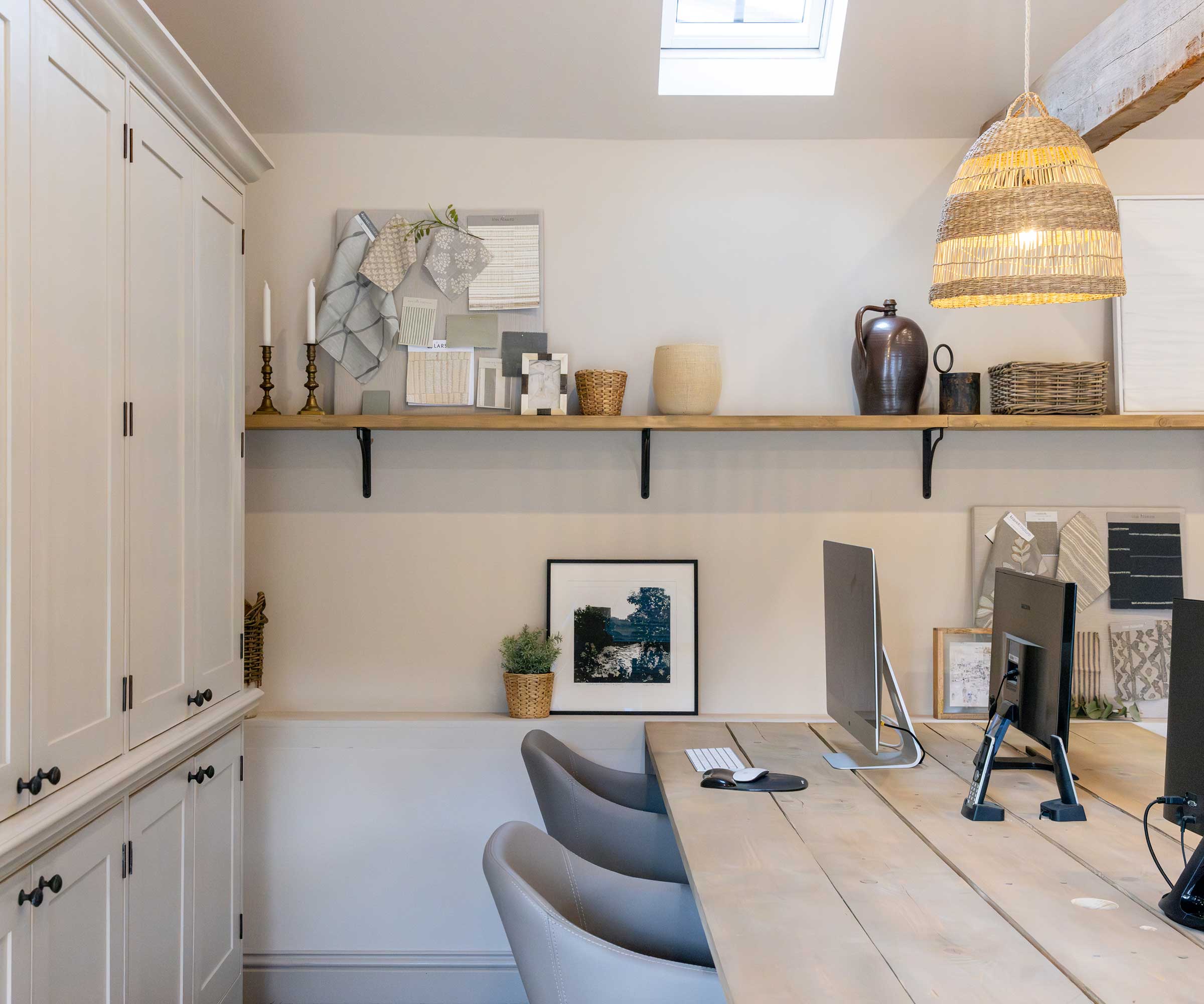 home office with cream cupboards and roof light