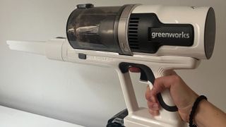 Greenworks 24V Deluxe Cordless Stick Vacuum used as a handheld