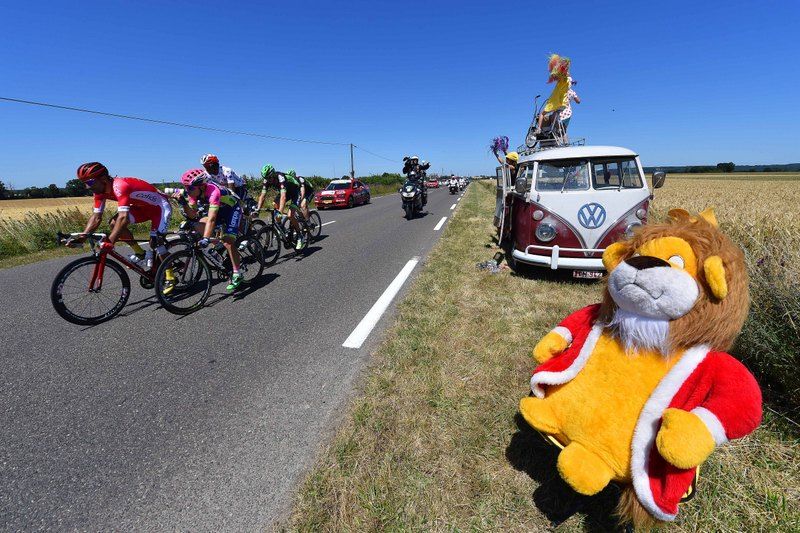 Some fans watch the Tour rolls by from their Kombi