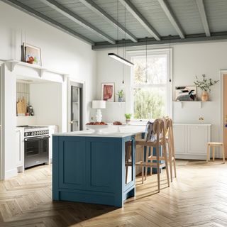 Open plan kitchen with blue kitchen island and wooden stools.