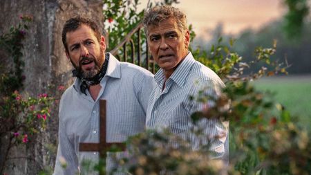 Ron and Jay looking confused as they stand in a garden in Netflix's Jay Kelly movie