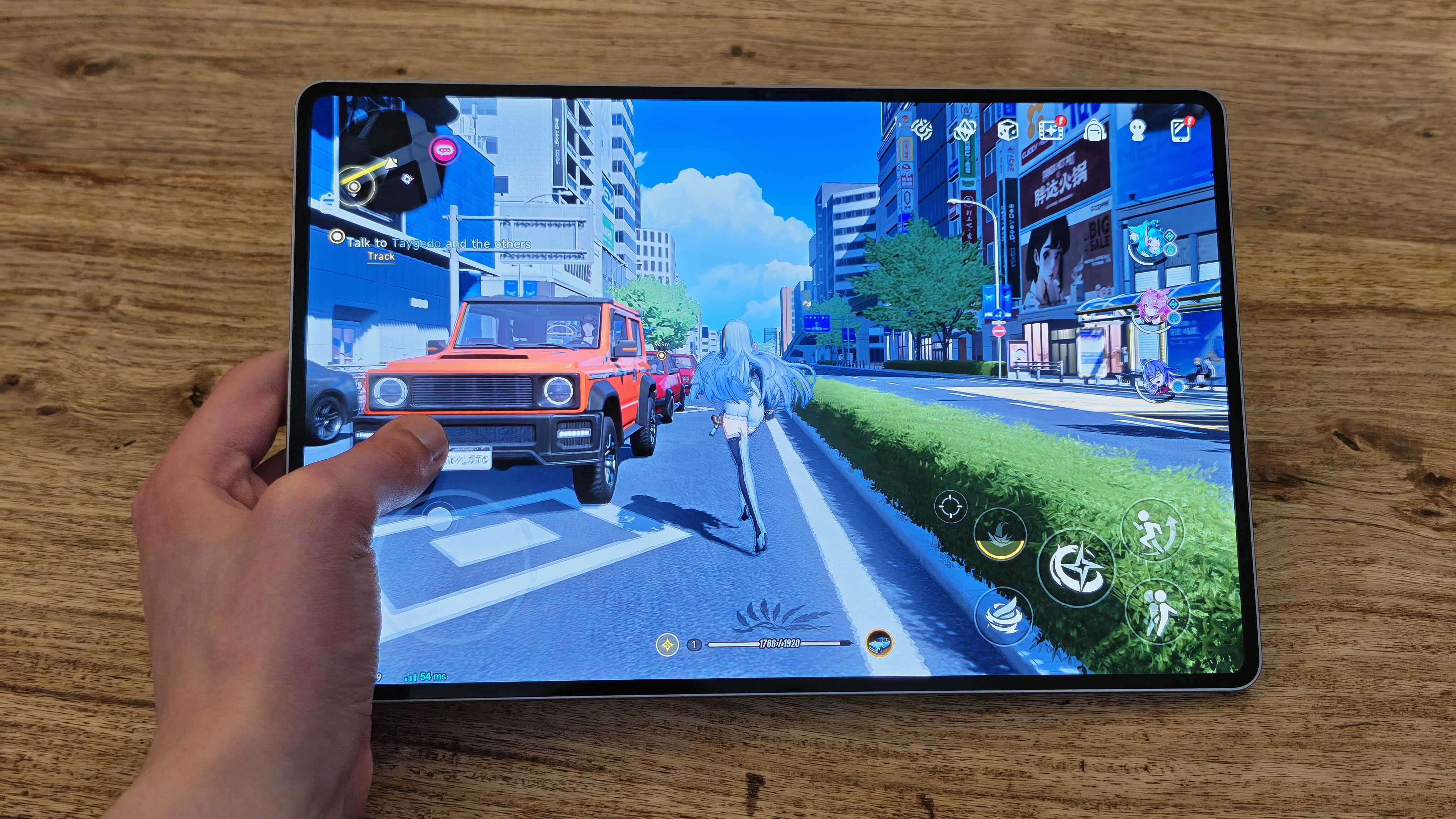 A photograph of the Honor MagicPad 4 in use on a wooden table.