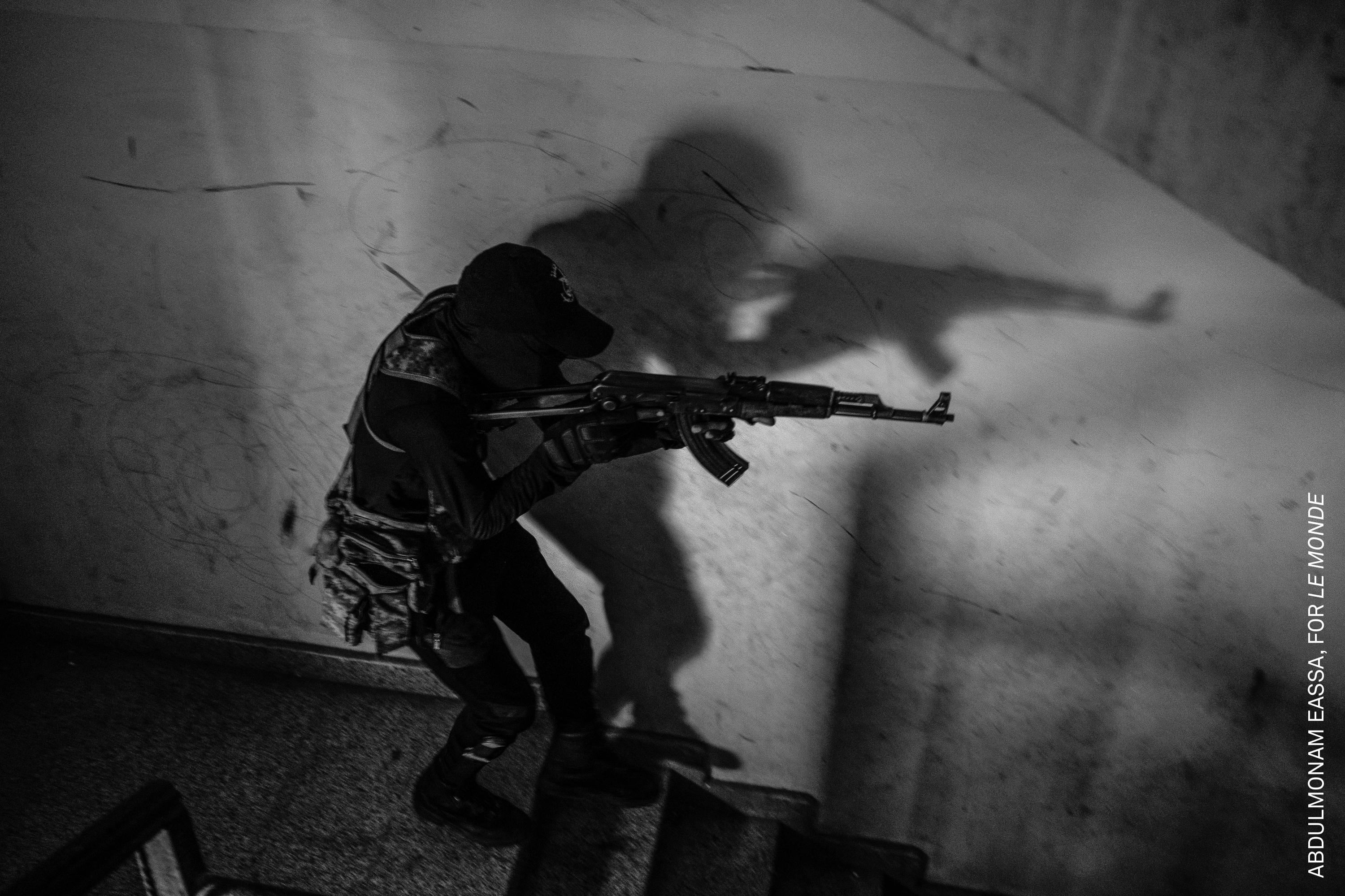 A soldier descends from a building as fighting continues. Frontline images like this are rare, due to heavily restricted access for journalists. Omdurman, Sudan, 1 November 2024