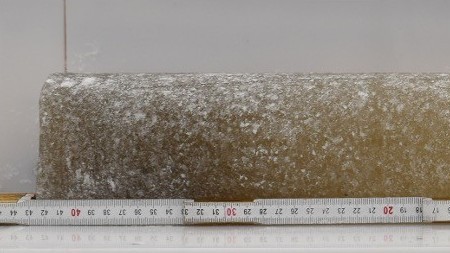 A photograph of the 6 million-year-old-ice core on a table.