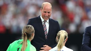 Prince William laughing with female footballers