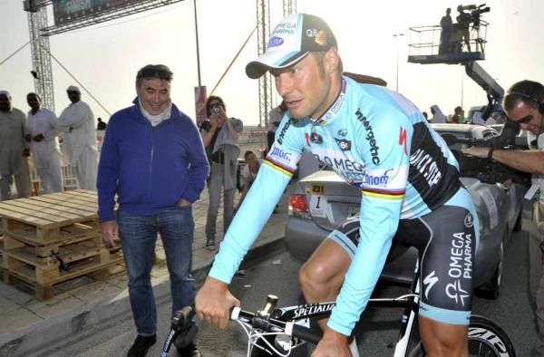 Eddy Merckx looks on as Tom Boonen (Omega Pharma-Quick Step) rides to the podium.