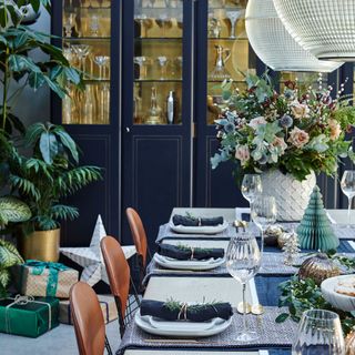 dining room with blue cupboard and potted plants