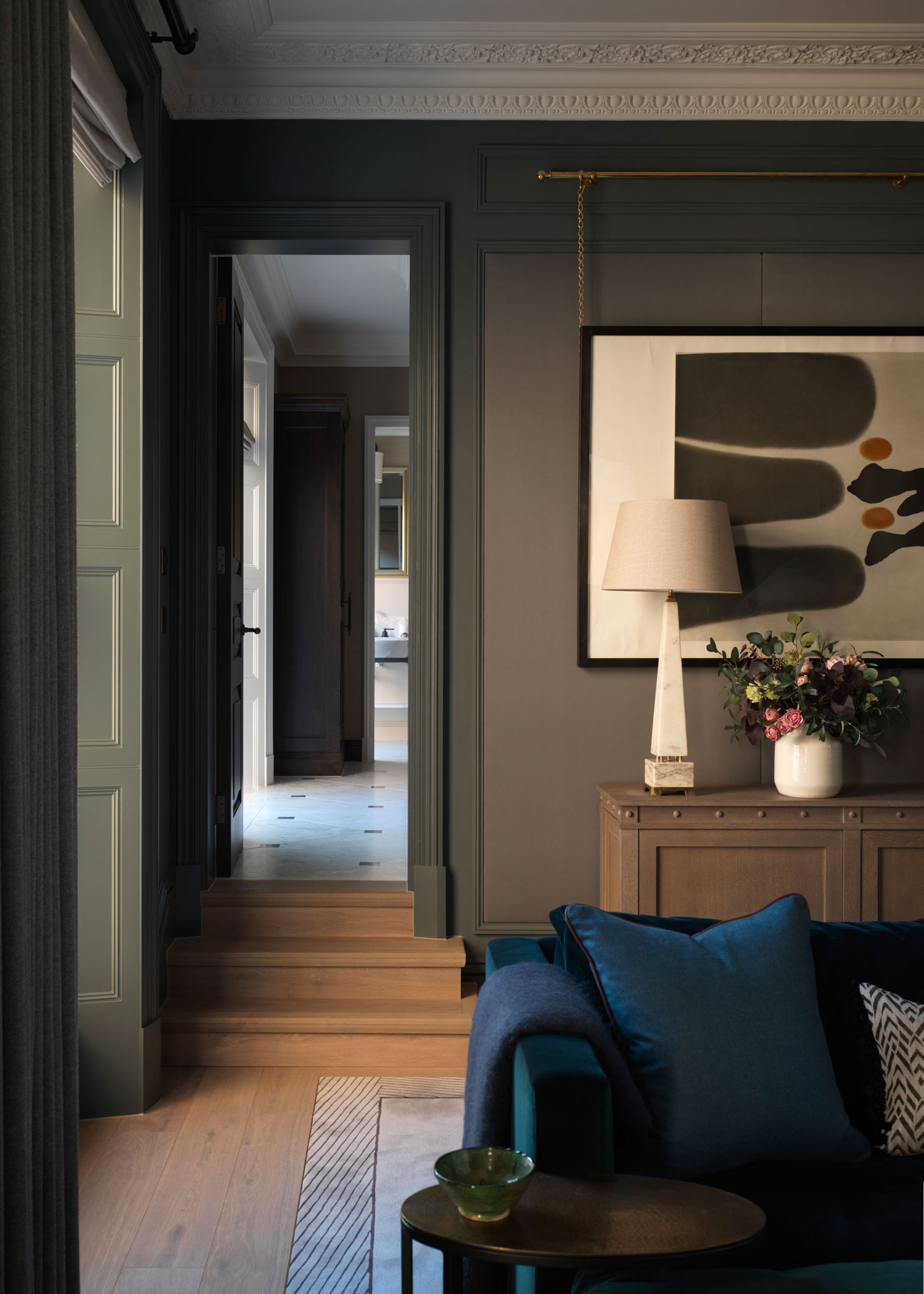 a blue sofa in a grey living room