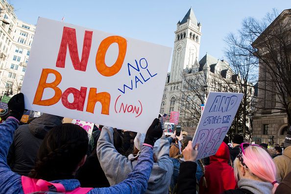 Protesters stand up against the immigration executive order by President Trump.