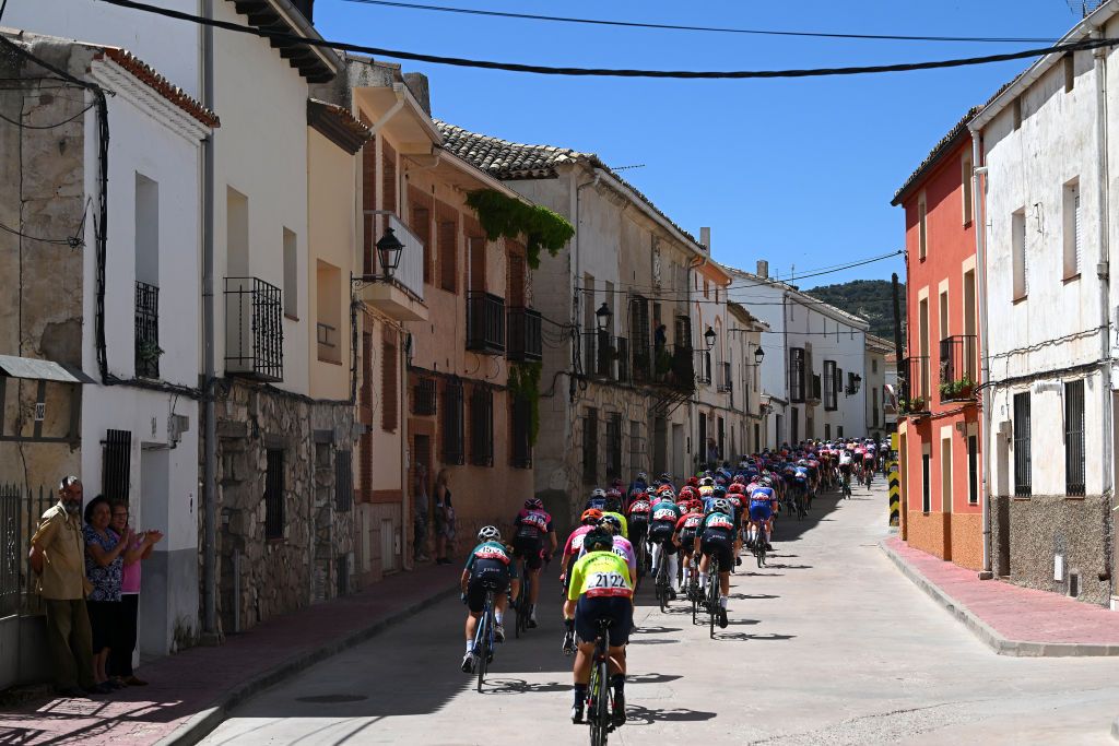 GUADALAJARA SPAIN MAY 04 A general view of the peloton passing through Alcocer Village while fans cheer during the 9th La Vuelta Femenina 2023 Stage 4 a 1331km stage from Cuenca to Guadalajara UCIWWT on May 04 2023 in Guadalajara Spain Photo by Dario BelingheriGetty Images