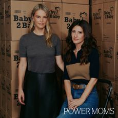 A portrait of Baby2Baby co-CEOs Kelly Sawyer Patricof (L) and Norah Weinstein (R) in front of cardboard boxes.
