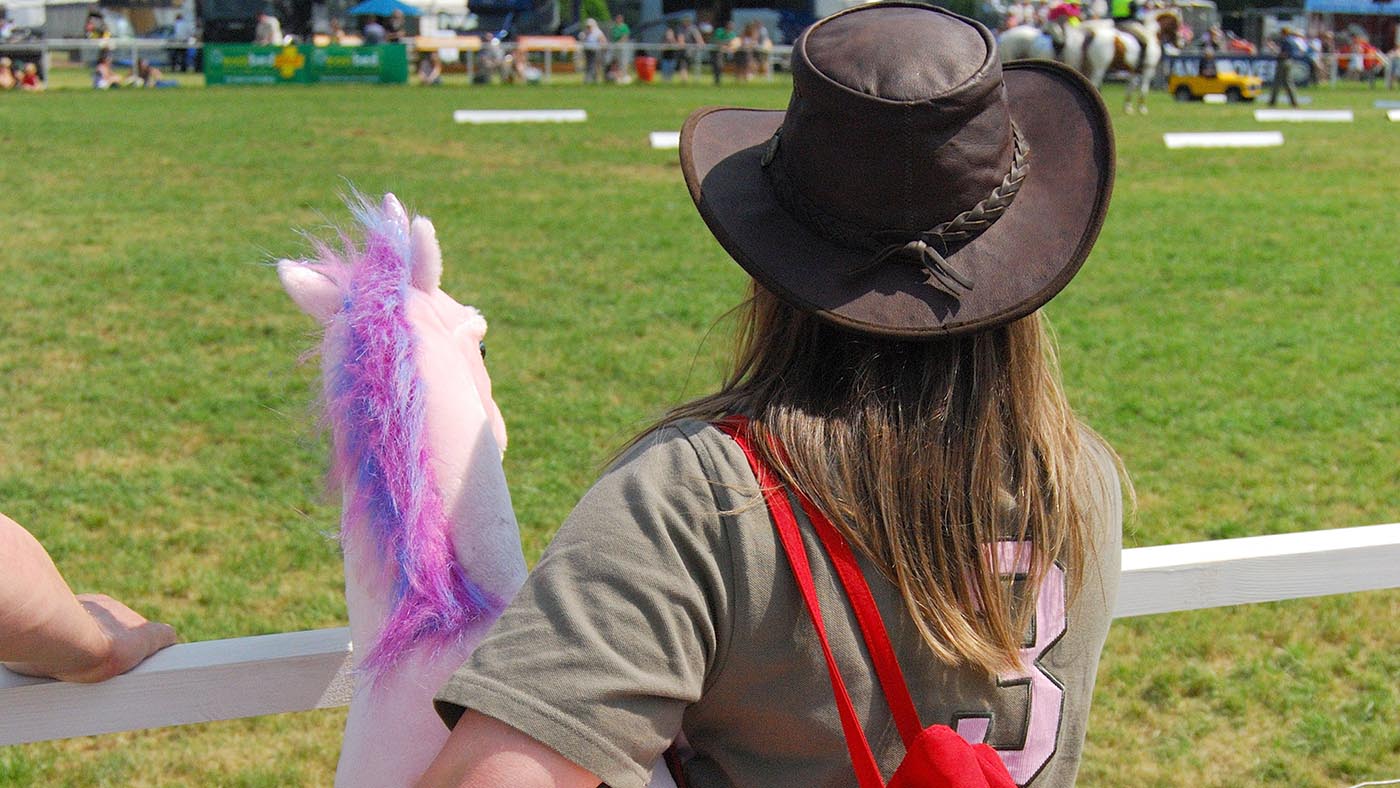 Girl holding toy pony, Royal Windsor Horse Show, Home Park, Windsor, Berkshire, England, United Kingdom. Image shot 2008. Exact date unknown.