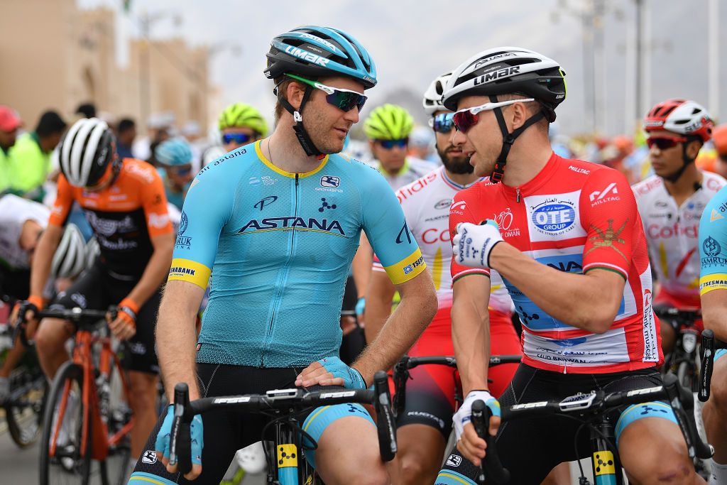 Alexey Lutsenko talks with teammate Hugo Houle before the start