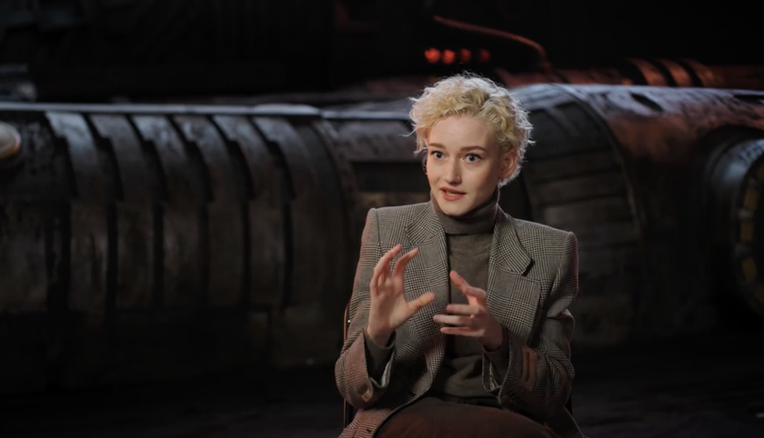 a blonde-haired woman sits in an interview