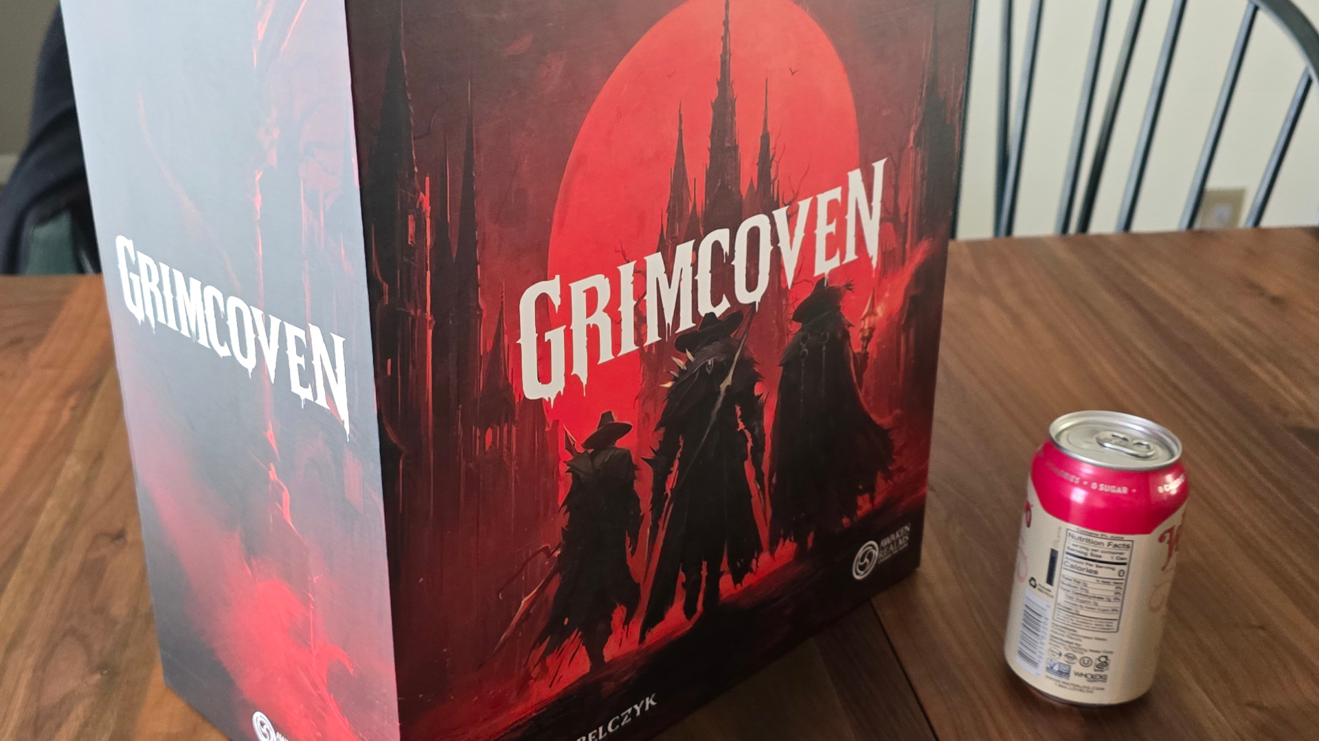 Grimcoven box on a wooden table beside a can