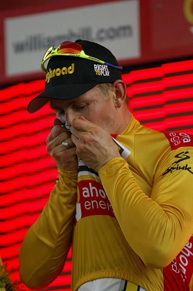 Andre Greipel kisses his golden jersey.