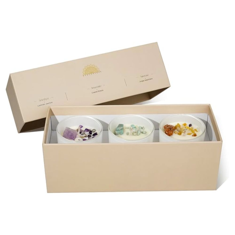 Three candles with colored crystals in a gift box