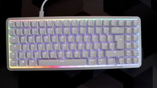 NZXT Function Elite MiniTKL with RGB lighting enabled on a desk.