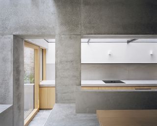 Kitchen with concrete and wood at Islington House by McLaren Excell