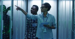 Black woman and Black man in a server room