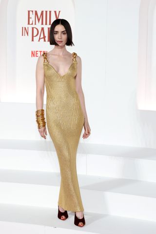 Lily Collins wears a gold Schiaparelli gown at the Emily in Paris part two image