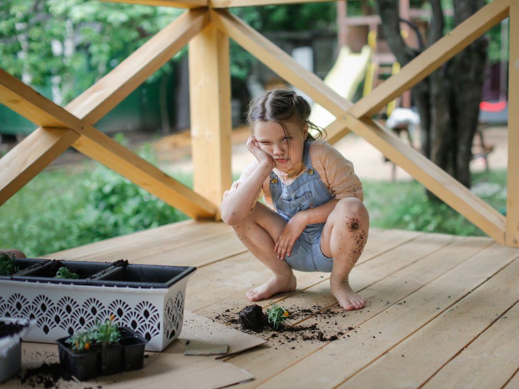 A frustrated looking girl with dirt
