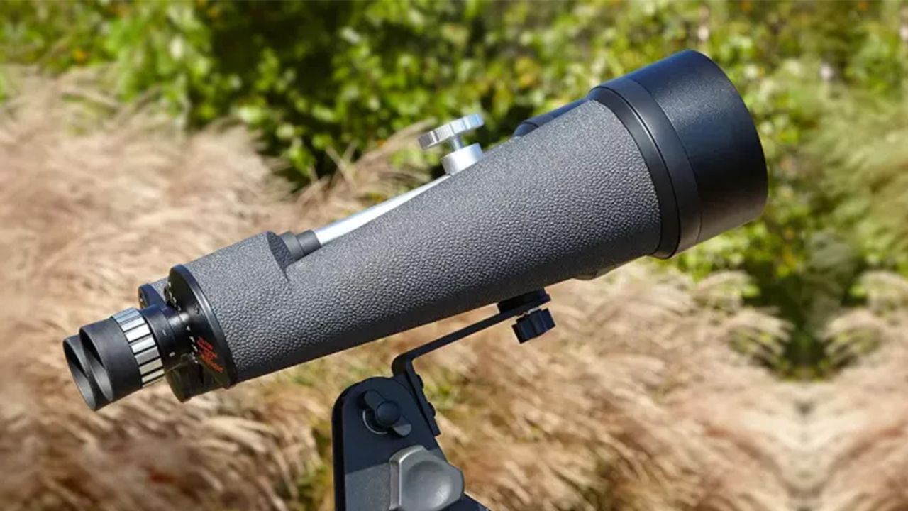 The Celestron SkyMaster 25x100 binoculars mounted on a tripod and pointing at the sky