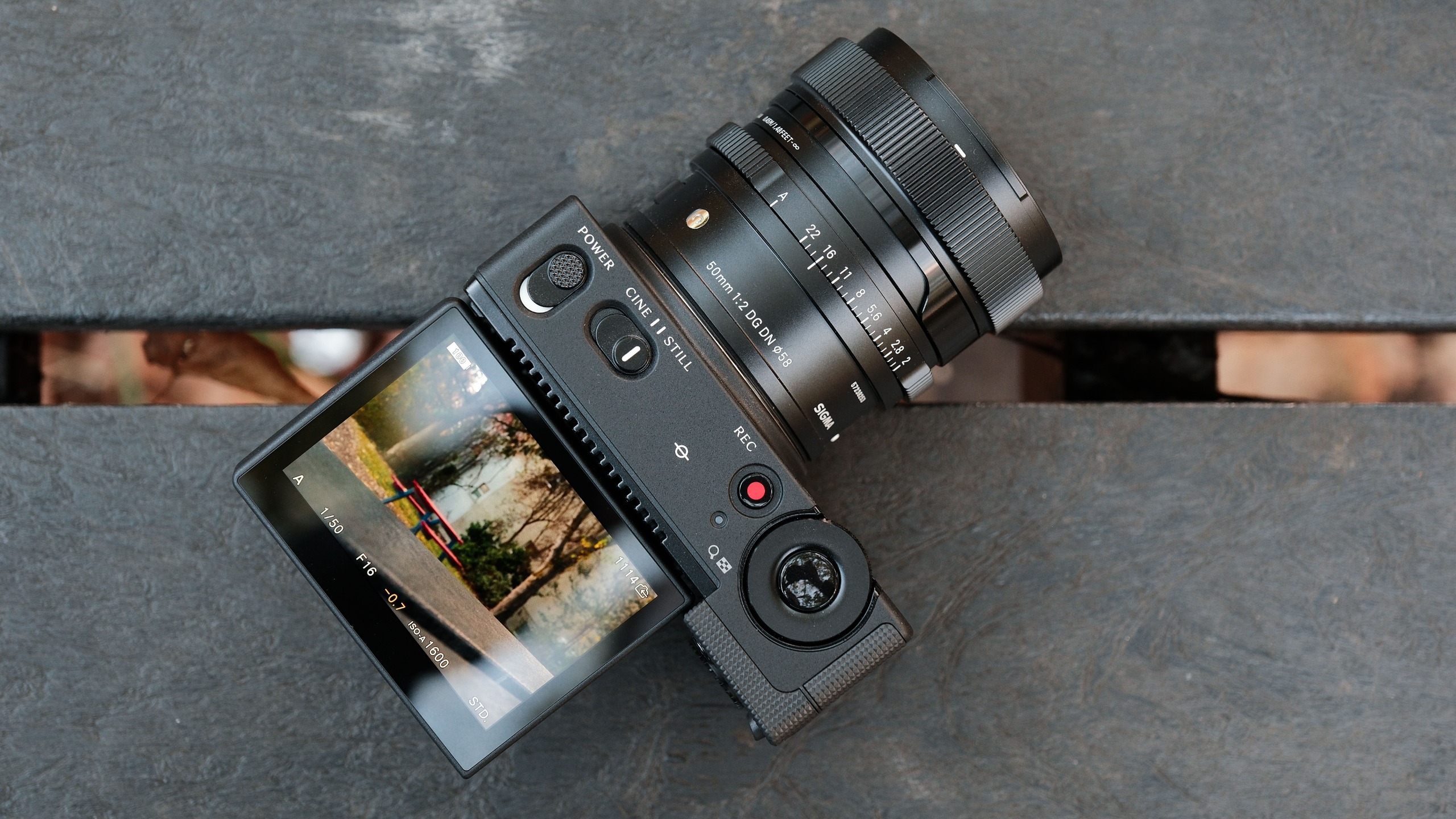 Overhead view of the Sigma FP2 with the articulated screen extended and a Sigma 50mm lens attached.