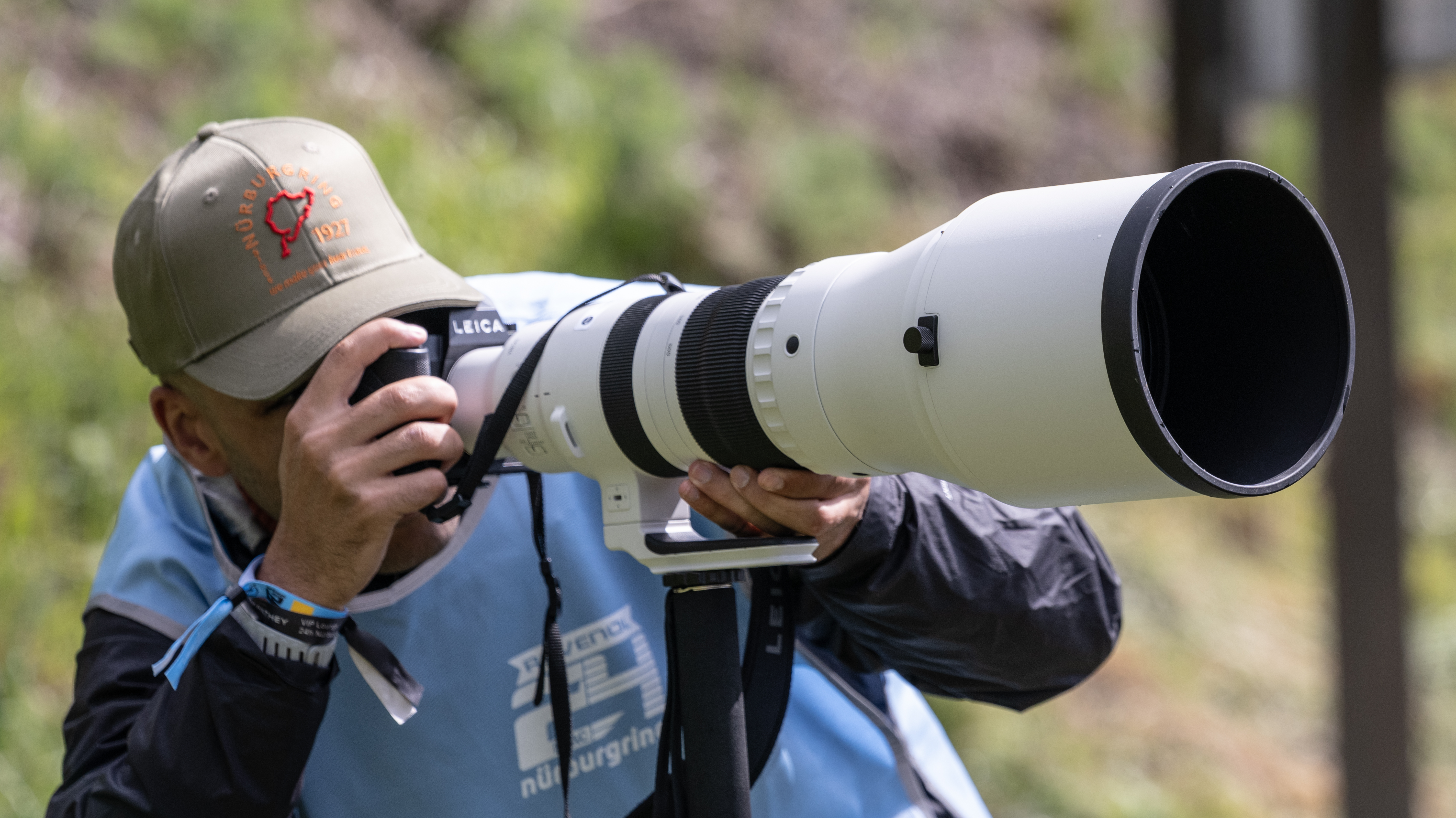 Photographer using a Sigma 500mm at a motoracing track with a monopod