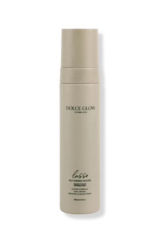 A bottle of Dolce Glow Lasso self tanning mousse set against a white background.