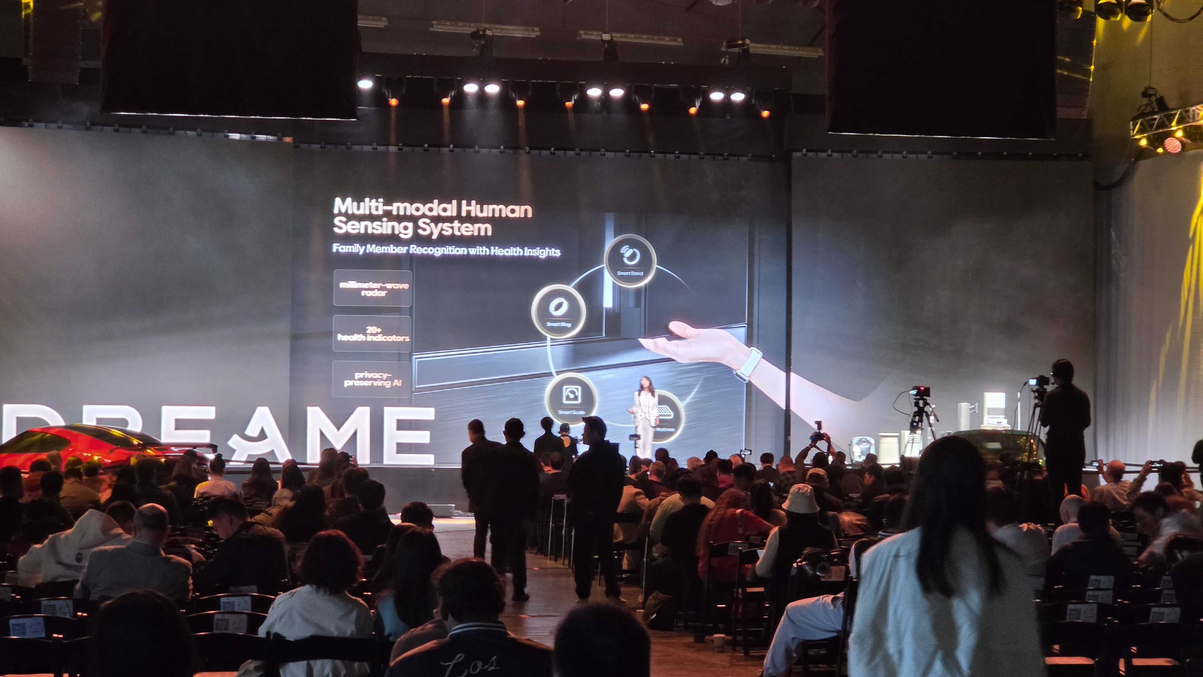 A Dreame spokesperson on stage, presenting the Dreame Fridge to a crowd of people