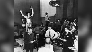 Orson Welles rehearsing a radio broadcast of H.G. Wells' classic, The War of the Worlds on October 10, 1938. The broadcast, which claimed that aliens from Mars had invaded New Jersey, terrified thousands of Americans. 
