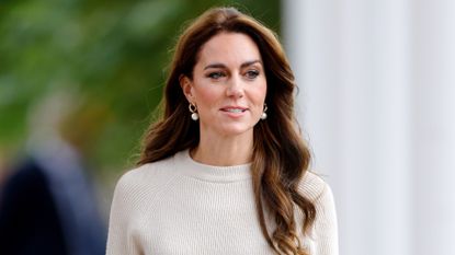 Catherine, Princess of Wales wears pearl earrings and a cream jumper as she visits Nottingham Trent University, to hear how they and the University of Nottingham are ensuring their students have the right mental health support around them as they begin the new university year, on October 11, 2023 in Nottingham, England.