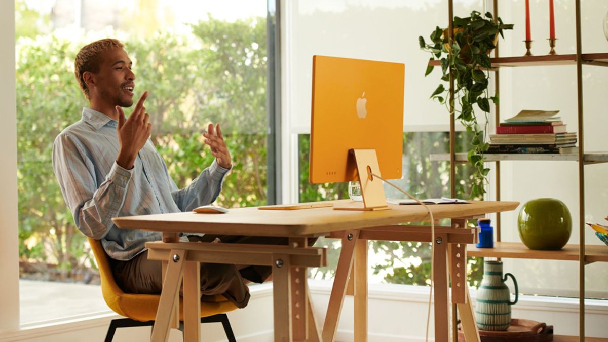 iMac 24-inch on a desk with a man