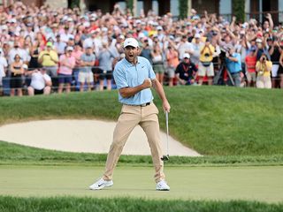 Scottie Scheffler celebrating after beating Collin Morikawa to the Memorial Tournament trophy on the 18th green