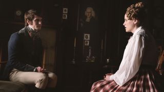 Tom Morley in jacket and breeches as James Ingham chats to Sophie Rundle as Ann Walker in a red tartan skirt and white blouse in Gentleman Jack
