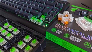 Razer BlackWidow V4 75% keyboard with keycaps removed showing orange and green switches