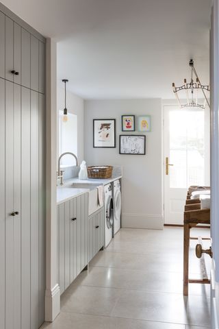 Utility room with grey cabinetry