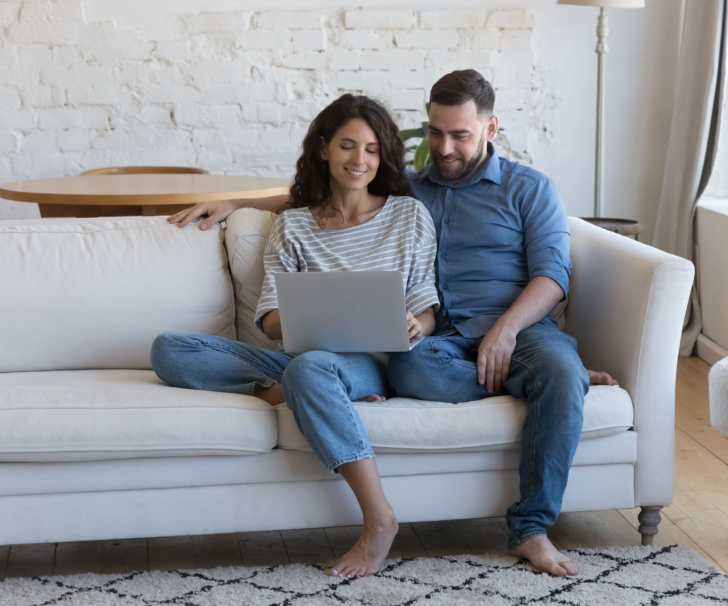 couple sitting and looking at laptop