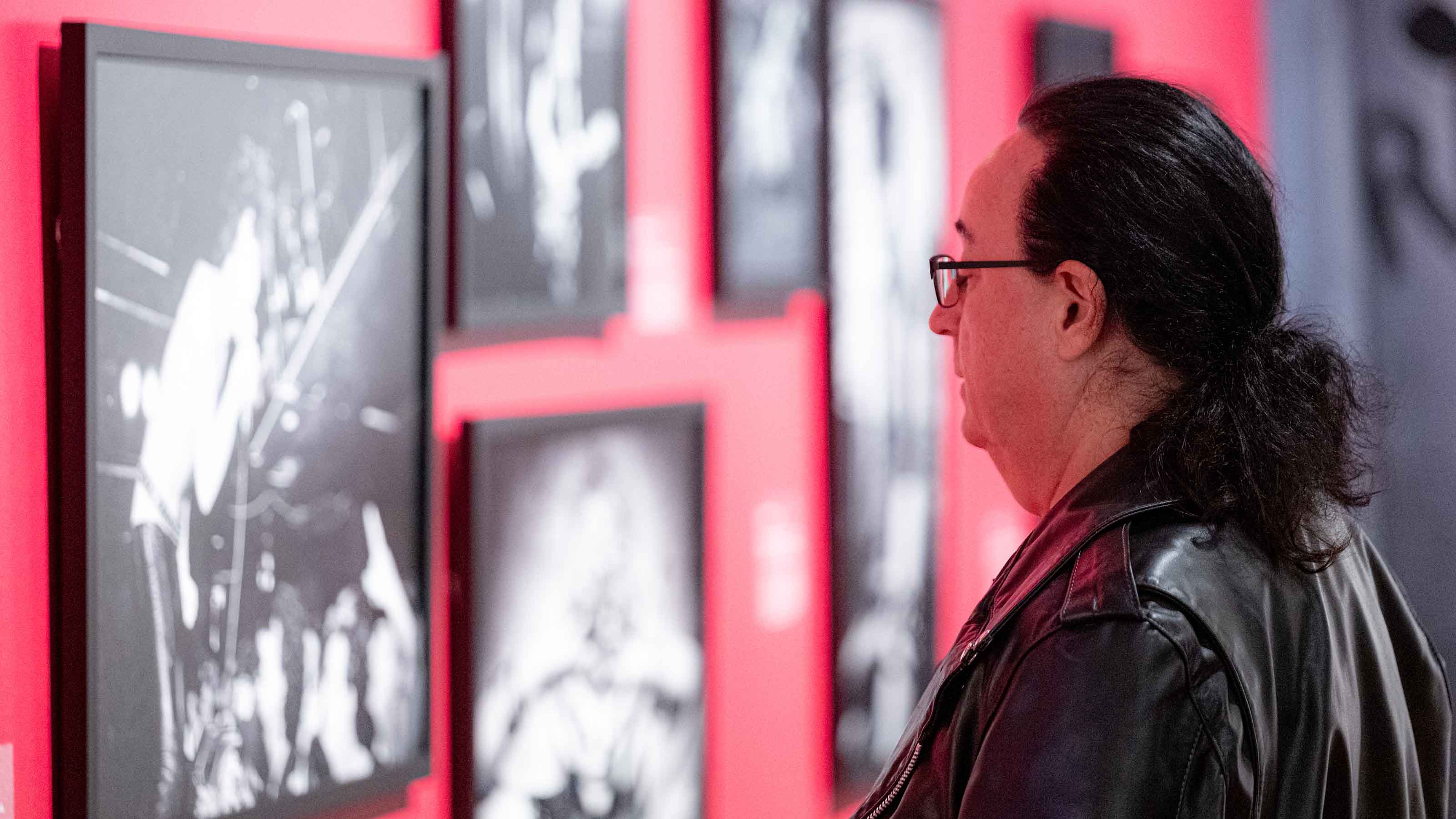 Museum patron studies punk photographs