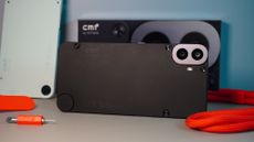 The CMF Phone (1) surrounded by some of the accessories for the phone